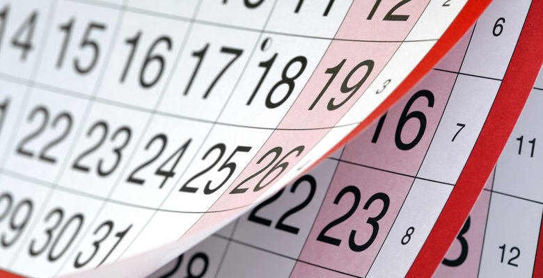 Pages in a calendar with large numbers for the dates with a red trim, some days are highlighted with red. 